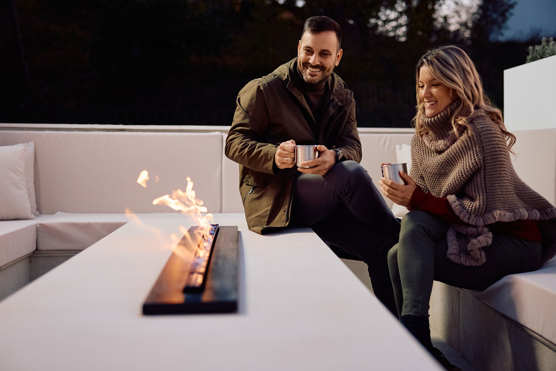 Relaxed Couple Enjoying Firepit Together Outdoors